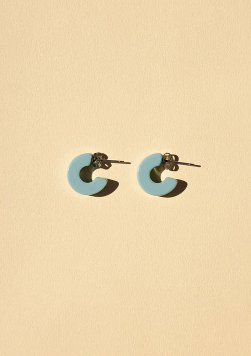 [Color: Turquoise] A small turquoise blue acetate hoop earring. 