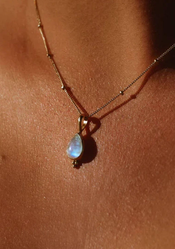 [Color: Silver] A white gold plated sterling silver necklace with rainbow moonstone charm. With an eighteen inch chain.