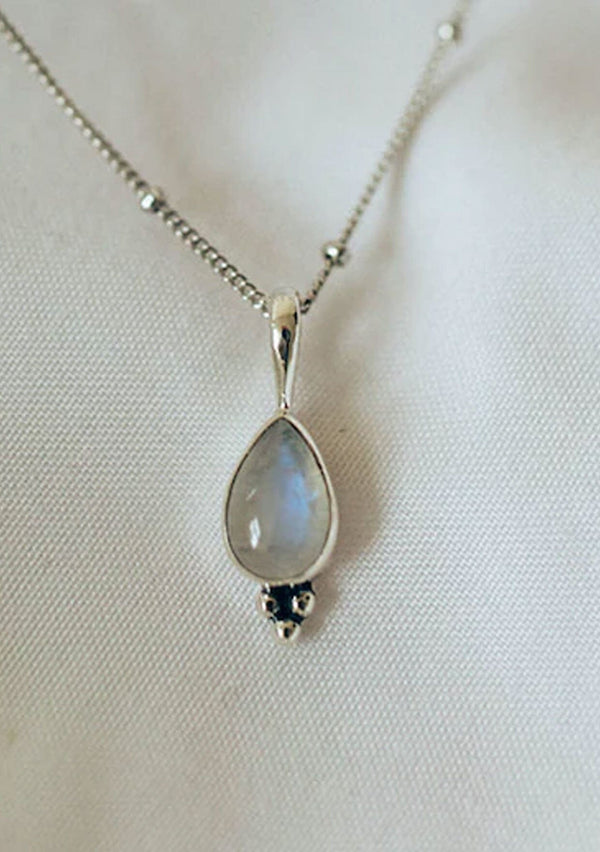 [Color: Silver] A white gold plated sterling silver necklace with rainbow moonstone charm. With an eighteen inch chain.