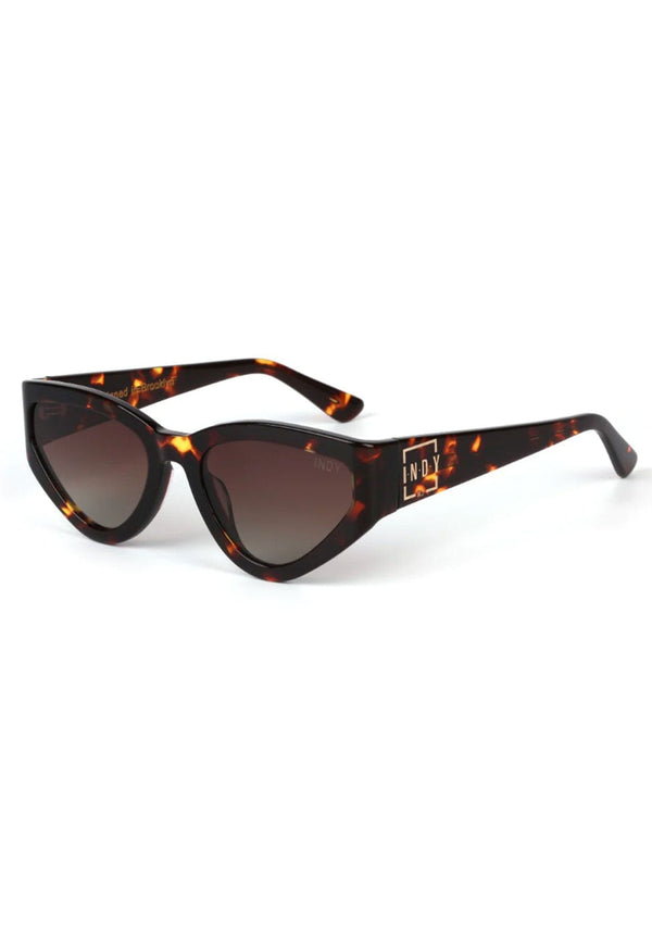 [Color: Tortoise] A modern take on the retro cat eye sunglasses in a brown tortoiseshell frame. 