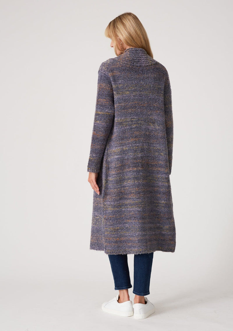 [Color: Denim Multi] A back facing image of a blonde model wearing a multi color blue knit long duster cardigan. A bohemian sweater coat with long sleeves, an open front, side pockets, and a rollover collar.