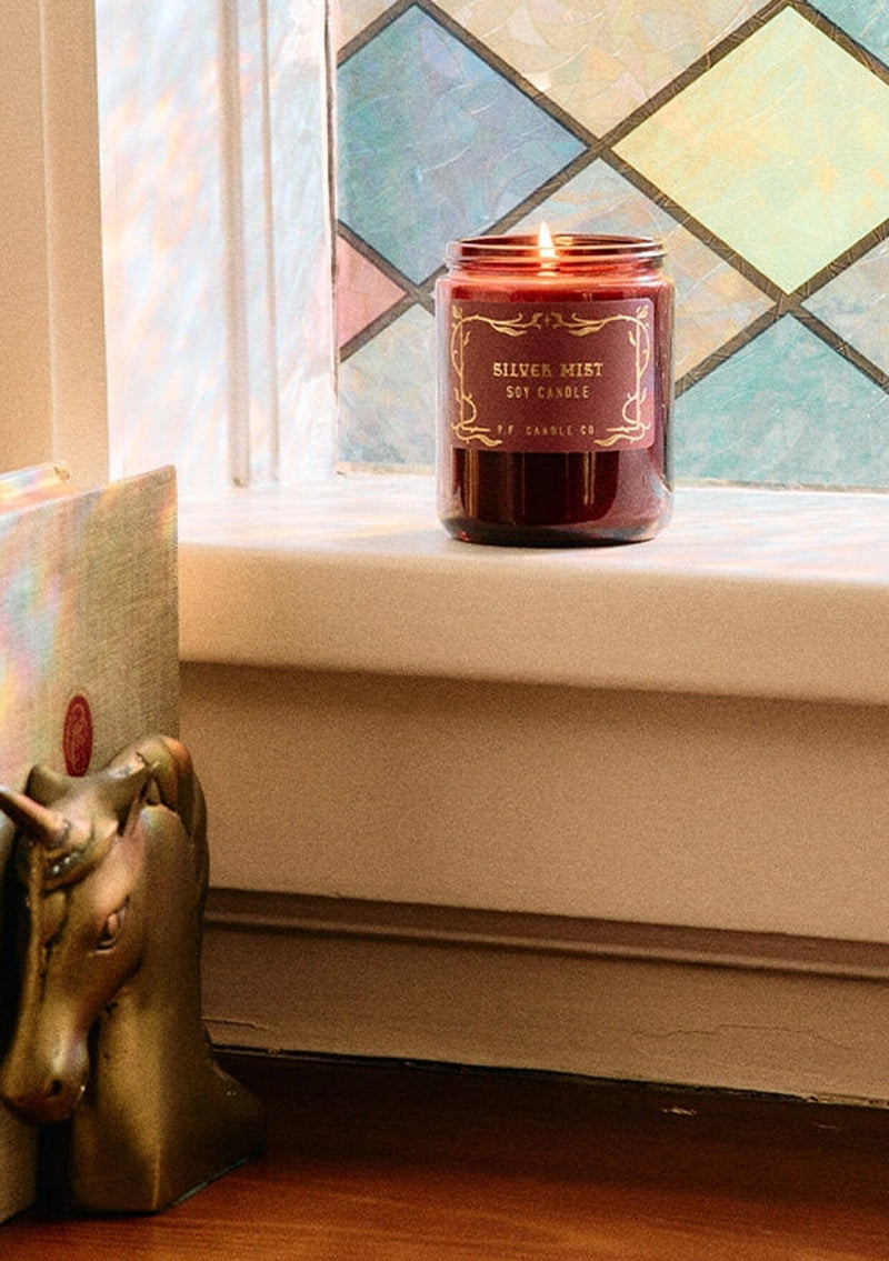 P.F. Candle in Silver Mist. A burgundy glass jar candle for the holidays. 