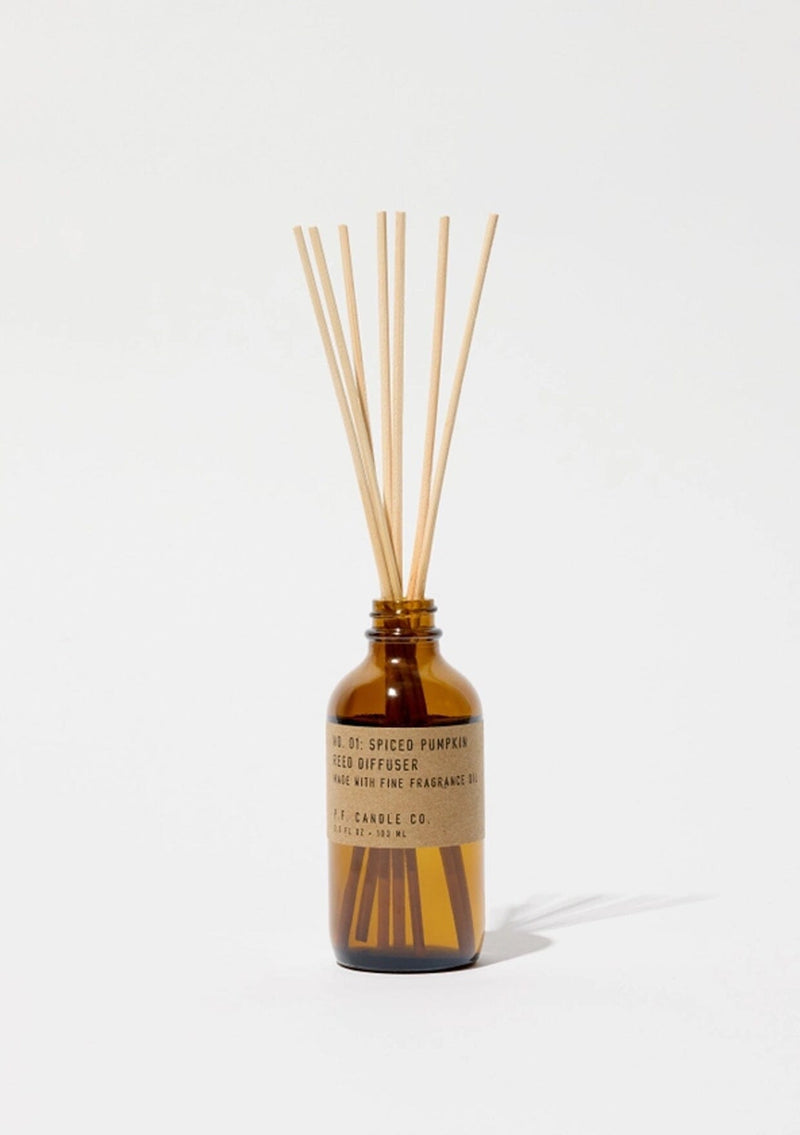 Pumpkin spice diffuser bottle with wooden sticks.