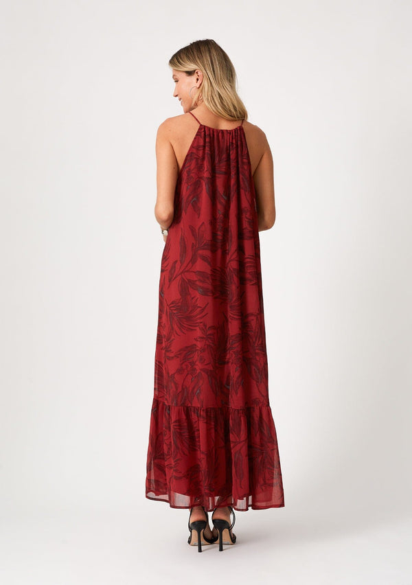 [Color: Wine/Charcoal] A back facing image of a blonde model wearing a dark red chiffon halter maxi dress. With a drawstring halter neckline, a front keyhole, a tiered skirt, and an ultra flowy silhouette.