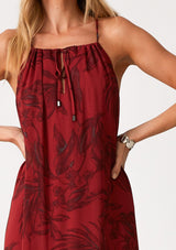 [Color: Wine/Charcoal] A close up front facing image of a blonde model wearing a dark red chiffon halter maxi dress. With a drawstring halter neckline, a front keyhole, a tiered skirt, and an ultra flowy silhouette.