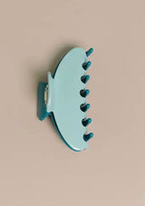 [Color: Robin] A two tone blue and teal medium sized hair clip by Nat and Noor. 