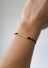 [Color: Onyx] Dainty gold bar bracelet with an adjustable black cord 
