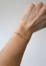 [Color: Blush] Dainty gold bar bracelet with an adjustable pink cord 