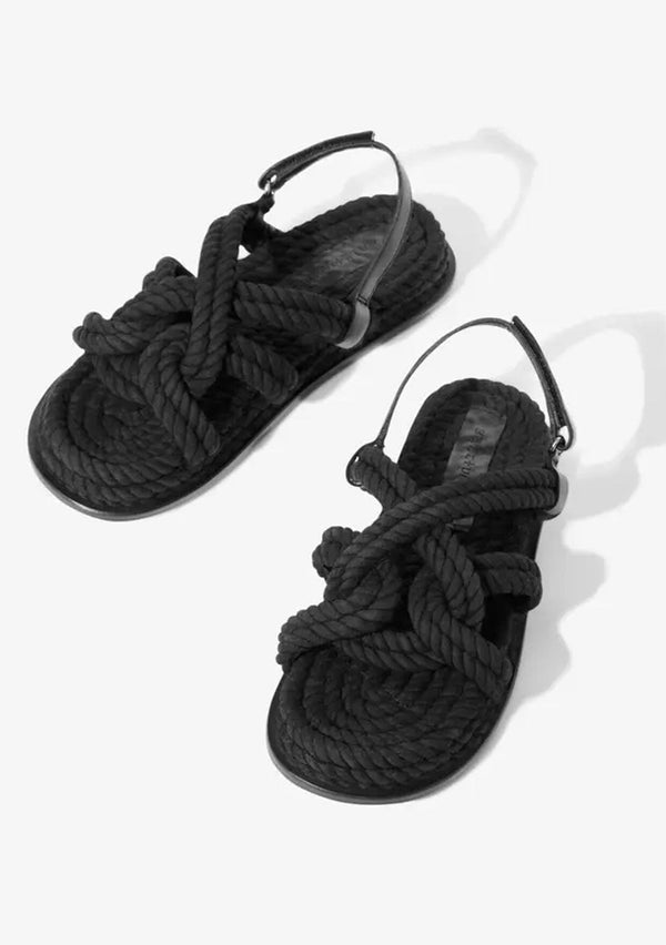 [Color: Black] A classic bohemian black rope sandal made with one hundred percent upcycled materials. With a slight platform and an adjustable Velcro strap. Sustainably and ethically made in India. 