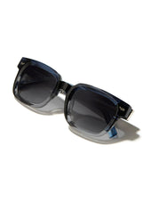 [Color: Cobalt] Sunglasses with a warm grey lens and a blue grey acetate frame.