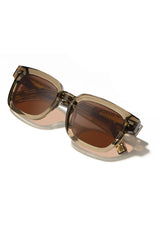 [Color: Sage] Sunglasses with a warm brown lens and a sage brown acetate frame.