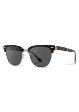 [Color: Black] Sunglasses with black frames and dark lenses  made by Shwood. 
