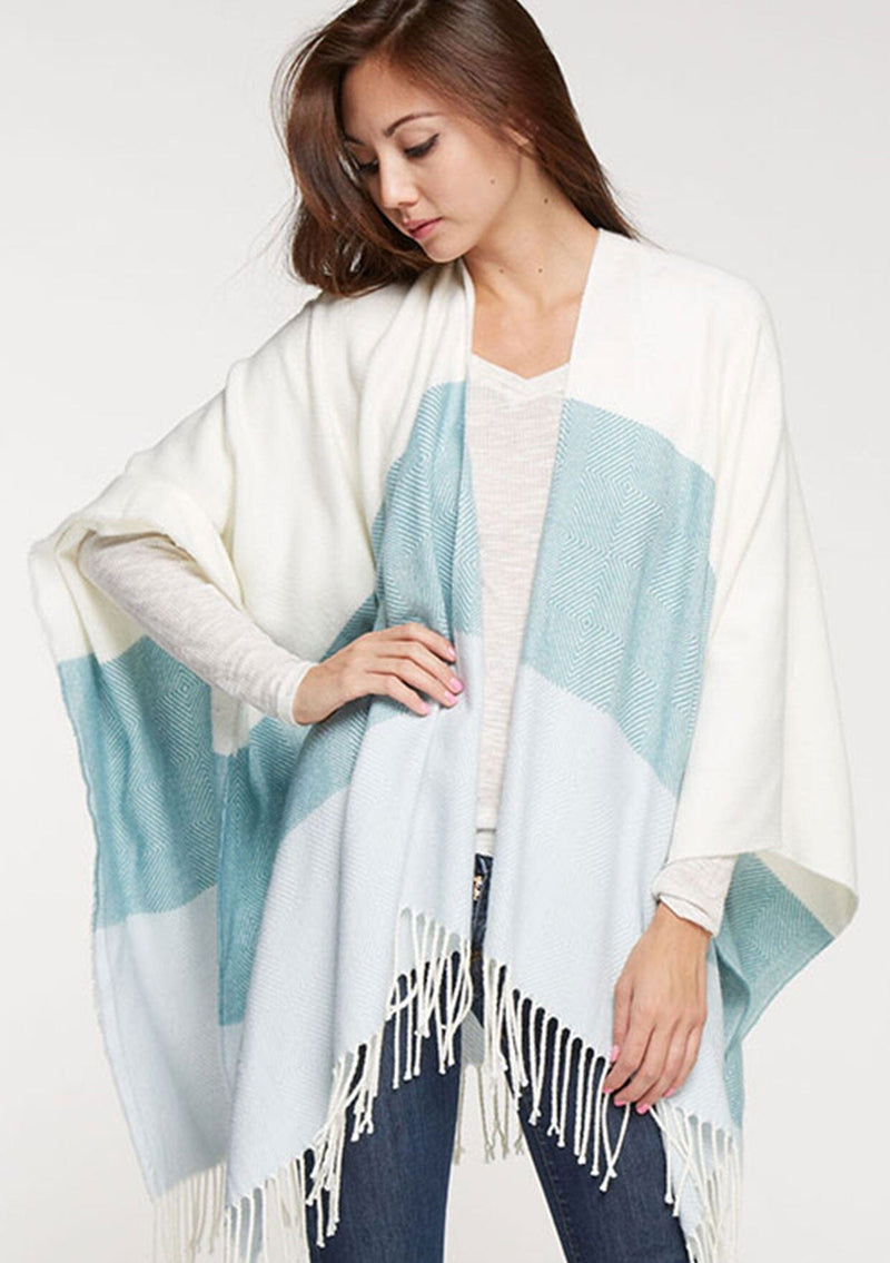 [Color: Vanilla/Mint] A bohemian fringed poncho in an ivory and mint block stripe.