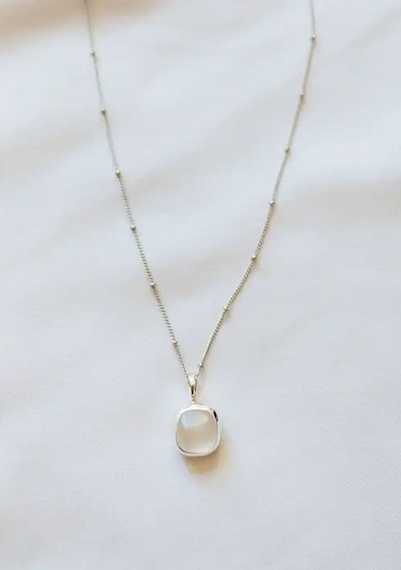 [Color: White] A white gold plated sterling silver base necklace with a unique sea glass charm in white.