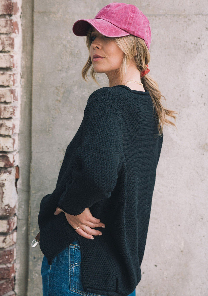 [Color: Black] Essential honeycomb knit sweater. A versatile layering style featuring a rolled neckline and hemline with side vents.