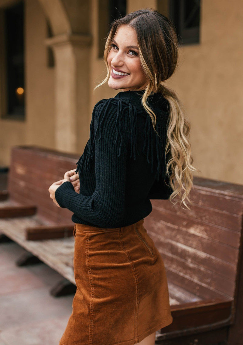[Color: Black] Bohemian chic off shoulder ribbed sweater with fringe detail. 