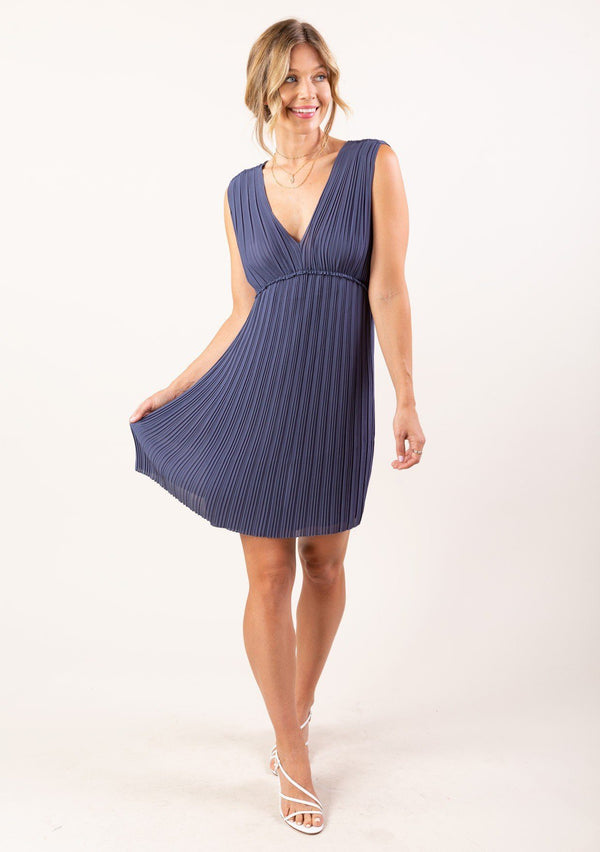 [Color: Steel Blue] A sleeveless pleated chiffon mini length dress. Featuring a flirty open tie back detail, a flattering empire waist with ruffle detail, and elegant pleating throughout. 