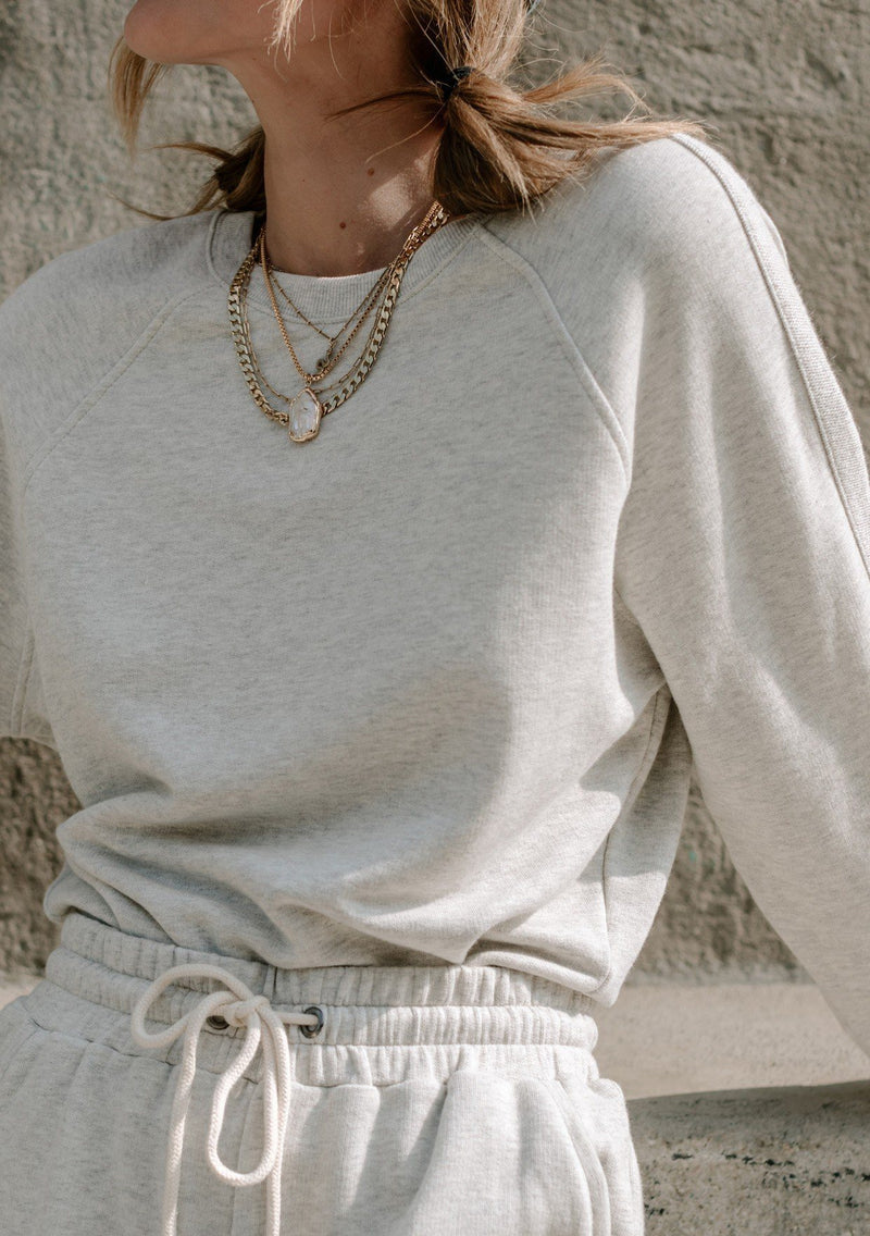 [Color: Heather Grey] A super soft hand feel elevates this essential sweatshirt to a whole new level of comfort. Featuring long raglan sleeves with a contrast trim, a relaxed easy fit, and a classic crew neckline. Whether you pair it with the matching drawstring shorts or jeans, this pullover will add a cool touch to your outfit. 