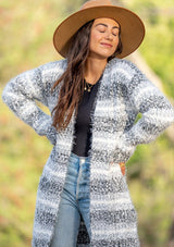 [Color: Black White Sky] An ultra fuzzy mid length cardigan in soft stripes. Features essential side pockets and an open front. Styled here with denim and camel boots for a classic Fall vibe. 