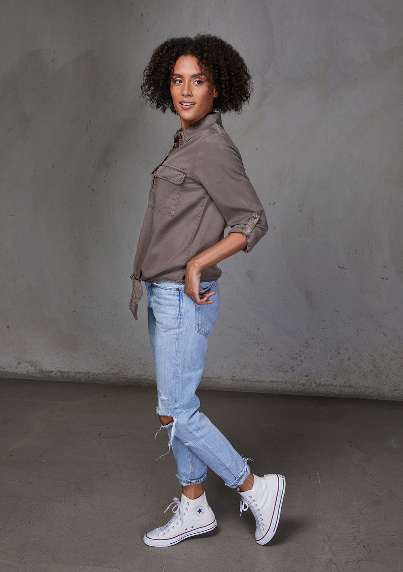 [Color: Mushroom] An ultra soft tie front top, featuring front flap patch pockets, button tab rolled sleeves and a trendy tie front detail. Paired here with denim.