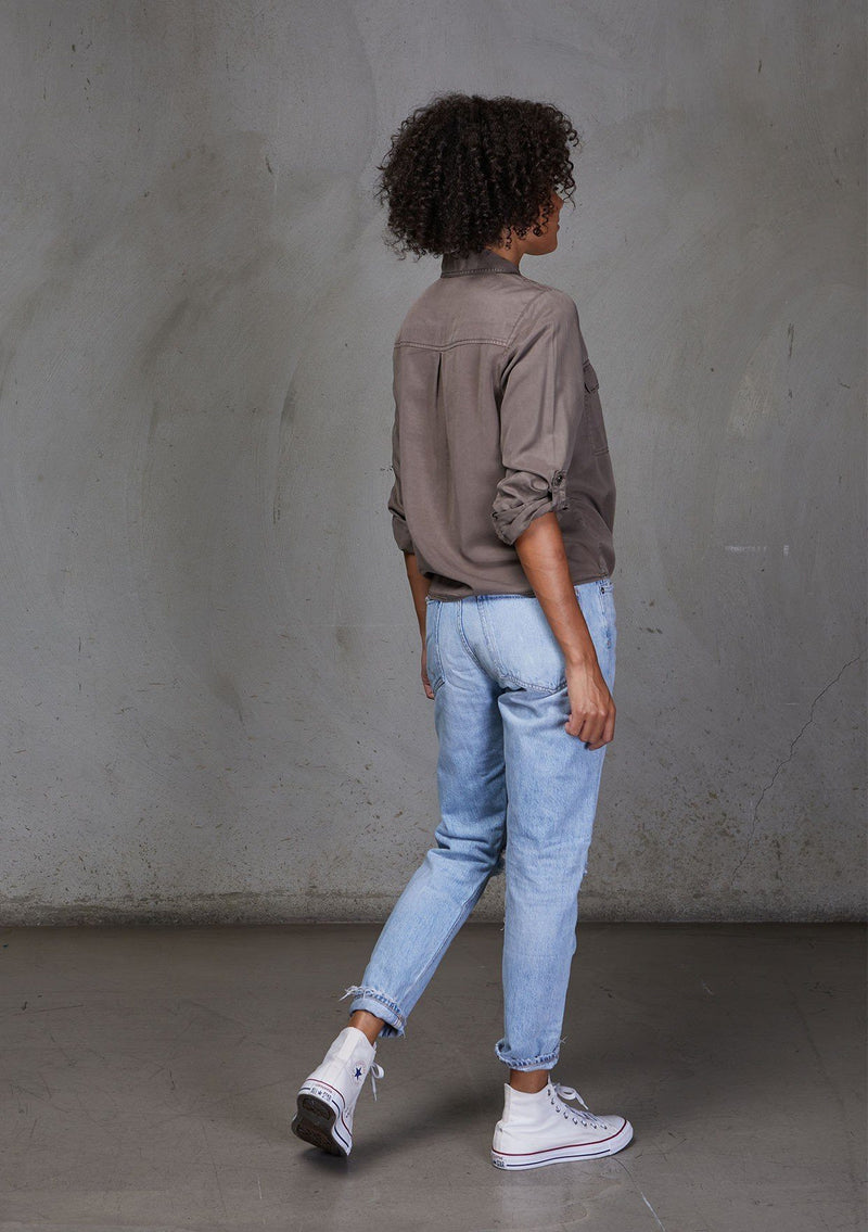 [Color: Mushroom] An ultra soft tie front top, featuring front flap patch pockets, button tab rolled sleeves and a trendy tie front detail. Paired here with denim.