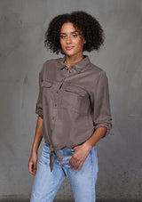 [Color: Mushroom] An ultra soft tie front top, featuring front flap patch pockets, button tab rolled sleeves and a trendy tie front detail. Paired here with denim.