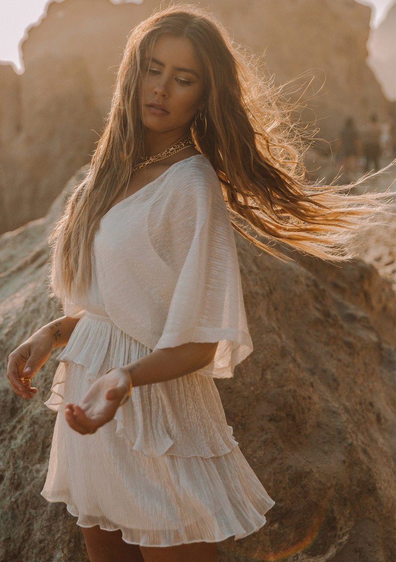 [Color: Ivory Gold] A luminous metallic mini dress. This ethereal style features a surplice neckline and flattering dolman sleeves that hit at the elbow. The tiered skirt adds movement to this perfect party dress. 