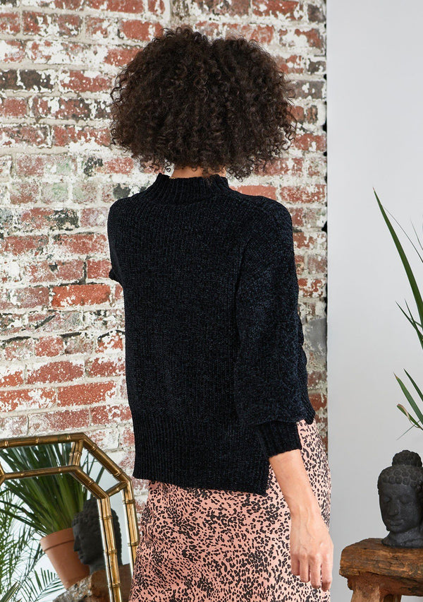 [Color: Black] Snowy days are no match against this ultra cozy cable knit sweater made with super soft chenille. Featuring a flattering ribbed funnel neck and a chic high low hemline with side vents. 