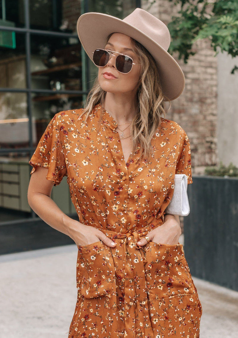 [Color: Caramel] Add some flower power to your wardrobe with our soft and silky floral print shirt dress. Featuring flirty flutter sleeves, delicate self covered buttons, and a flattering waist defining self tie belt. Styled here with heels. 