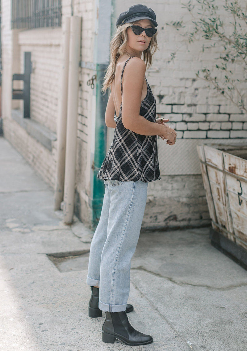 [Color: Black] A lightweight cotton plaid camisole featuring a sexy wrap back detail with side tie closure, double spaghetti straps, and a flattering scooped neckline. An ultra cute style that is paired here with denim and heeled sandals.