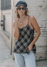 [Color: Black] A lightweight cotton plaid camisole featuring a sexy wrap back detail with side tie closure, double spaghetti straps, and a flattering scooped neckline. An ultra cute style that is paired here with denim and heeled sandals.