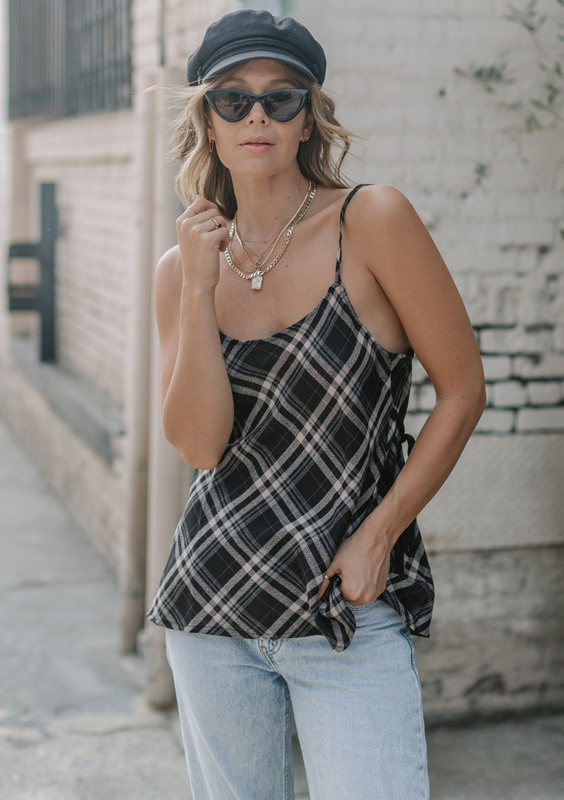 [Color: Black] A lightweight cotton plaid camisole featuring a sexy wrap back detail with side tie closure, double spaghetti straps, and a flattering scooped neckline. An ultra cute style that is paired here with denim and heeled sandals.