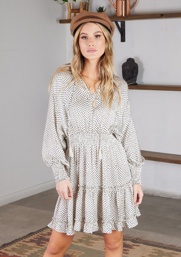 [Color: Ivory Black] The perfect bohemian dress for every season! Our polka dot mini dress features a flattering smocked elastic waist, long voluminous sleeves, and a split v neckline with tassel ties. 