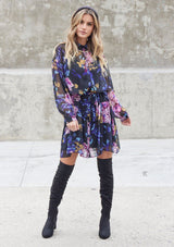 [Color: Black Royal] Get ready to take on Fall with our versatile floral print mini dress. Featuring an elegant self covered button up front, a waist defining self tie belt, and a dropped waist. Pair it with boots for an effortlessly cool Fall look. 