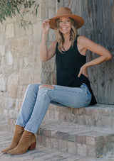 [Color: Black] Girl wearing a mixed media black sleeveless tank top with a scoop neckline.