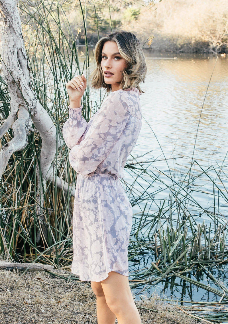 [Color: Grey/Blush] Girl wearing a pink and grey floral long sleeve mini dress.