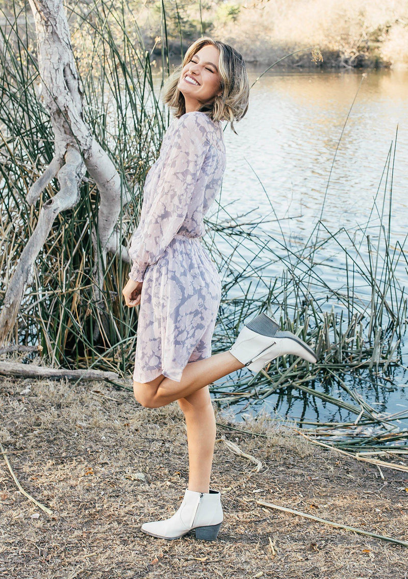 [Color: Grey/Blush] Girl wearing a pink and grey floral long sleeve mini dress.