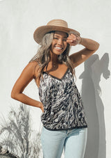 [Color: Grey] Girl wearing an abstract print lace trim camisole tank top. 