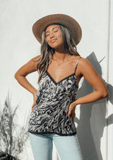 [Color: Grey] Girl wearing an abstract print lace trim camisole tank top. 