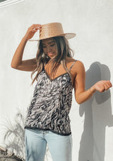 [Color: Grey] Girl wearing an abstract print lace trim camisole tank top. 