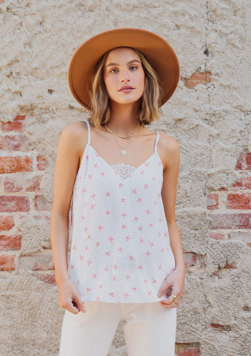 [Color: Ivory/Coral] Girl wearing a white polka dot lace trim tank.