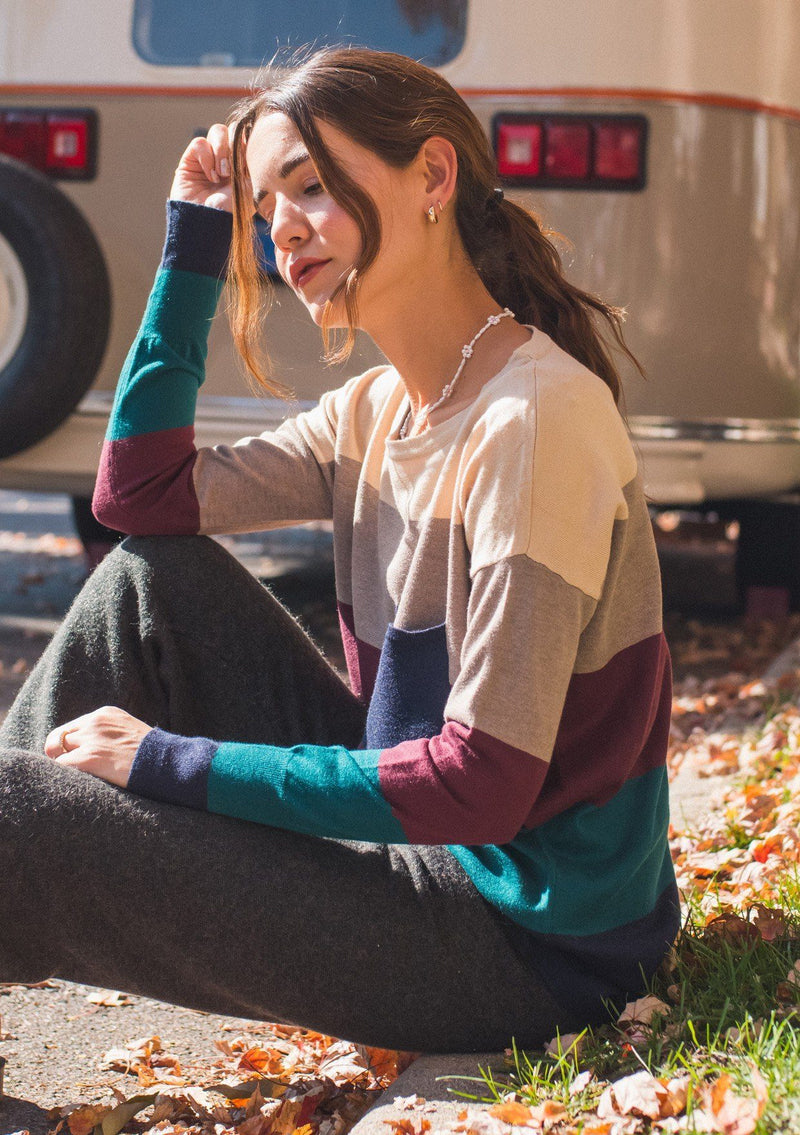 [Color: Heather Eclipse] A bold color block striped knit sweater, featuring a contrast front pocket, a wide crew neckline, and an easy, relaxed fit. Perfectly soft and cozy, this lightweight pullover looks great styled with denim or as shown here with woolly joggers. 