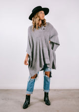 [Color: Heather Grey] Super soft knit sweater poncho. Featuring a shawl collar neckline with functional shank buttons, a front kangaroo pocket, and contrast ribbed trim. 