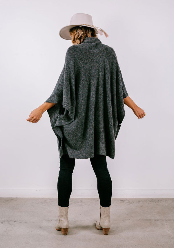 [Color: Heather Charcoal] Super soft knit sweater poncho. Featuring a shawl collar neckline with functional shank buttons, a front kangaroo pocket, and contrast ribbed trim. 
