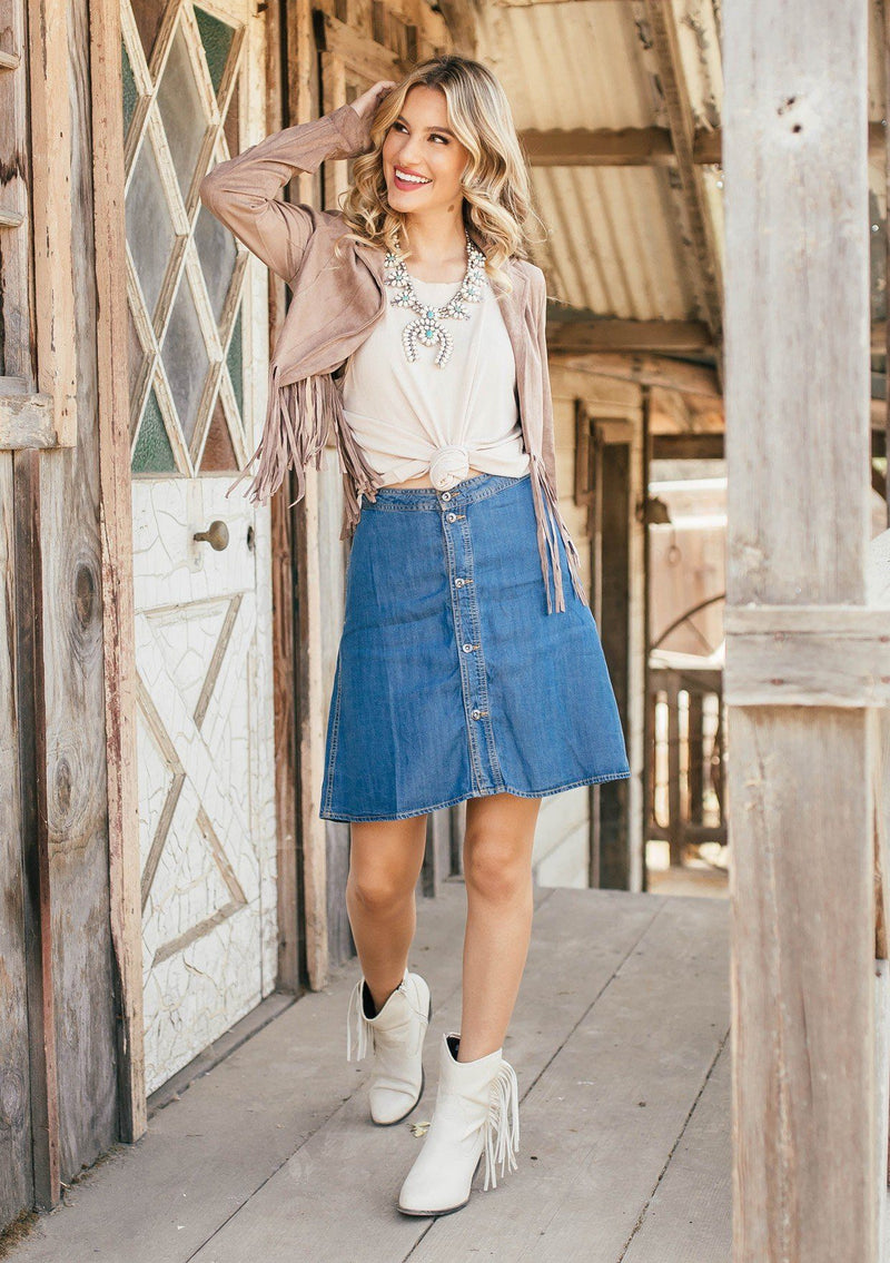 [Color: Vintage] Classic denim blue button front mini skirt, featuring a flattering a line fit, a button up front, and essential side pockets. Worn here with a fringe jacket.
