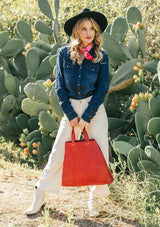 [Color: Dark Indigo] A classic denim blue button up shirt, featuring two front patch pockets with a button flap closure, a snap button up front, and a western style yoke. A staple button up style that pairs effortlessly with white denim. Worn here with a red bandana.