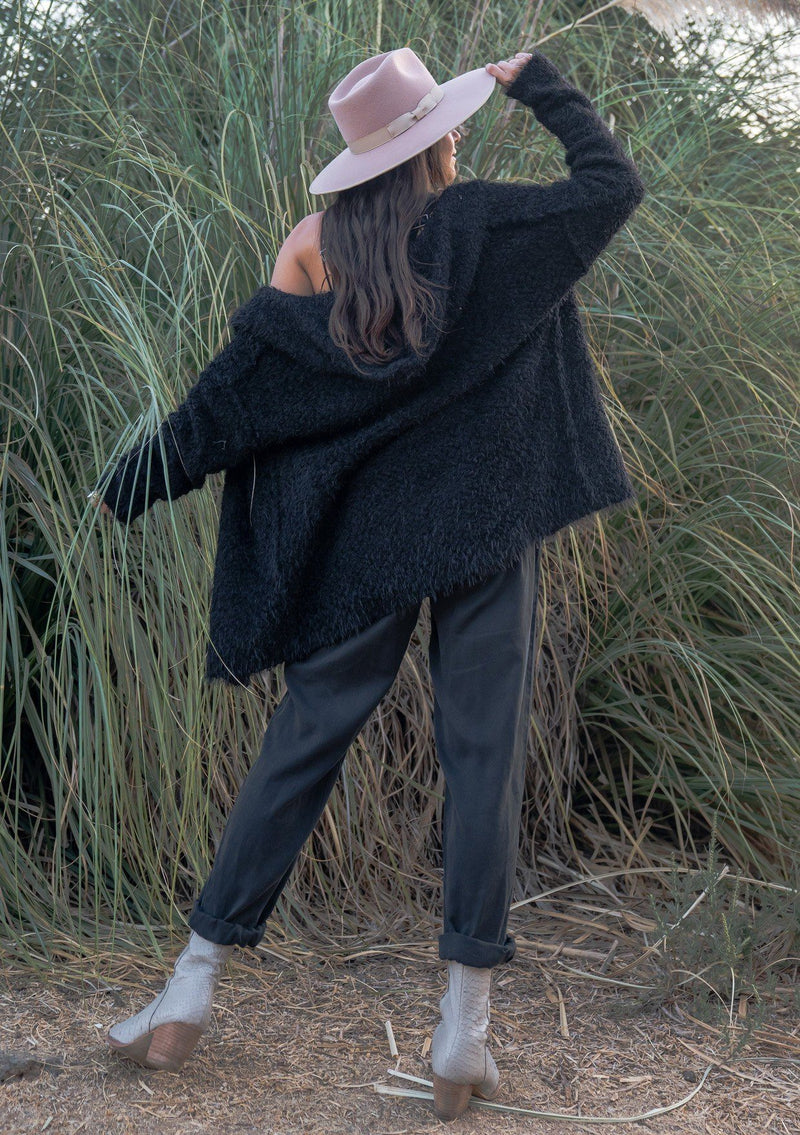[Color: Black] A slouchy fuzzy hoodie cardigan. Featuring a cozy oversize hood, a relaxed open front, and a unique reverse seam detail. A buttery soft texture adds a luxe quality to this versatile sweater.