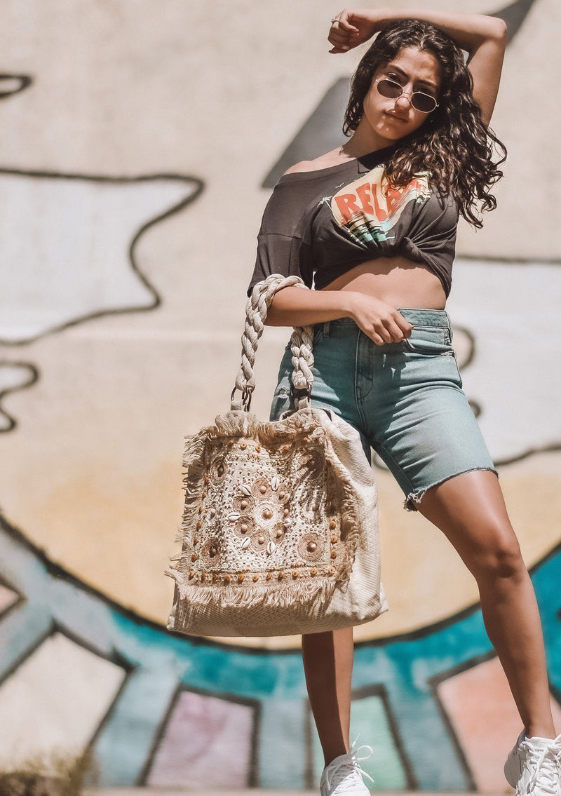 [Color: Natural] Girl carrying a boho beach tote.