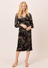 [Color: Black] A gorgeous soft and silky midi wrap dress in a pretty botanical floral print. This classic silhouette features long voluminous sleeves and a belted waist for definition.