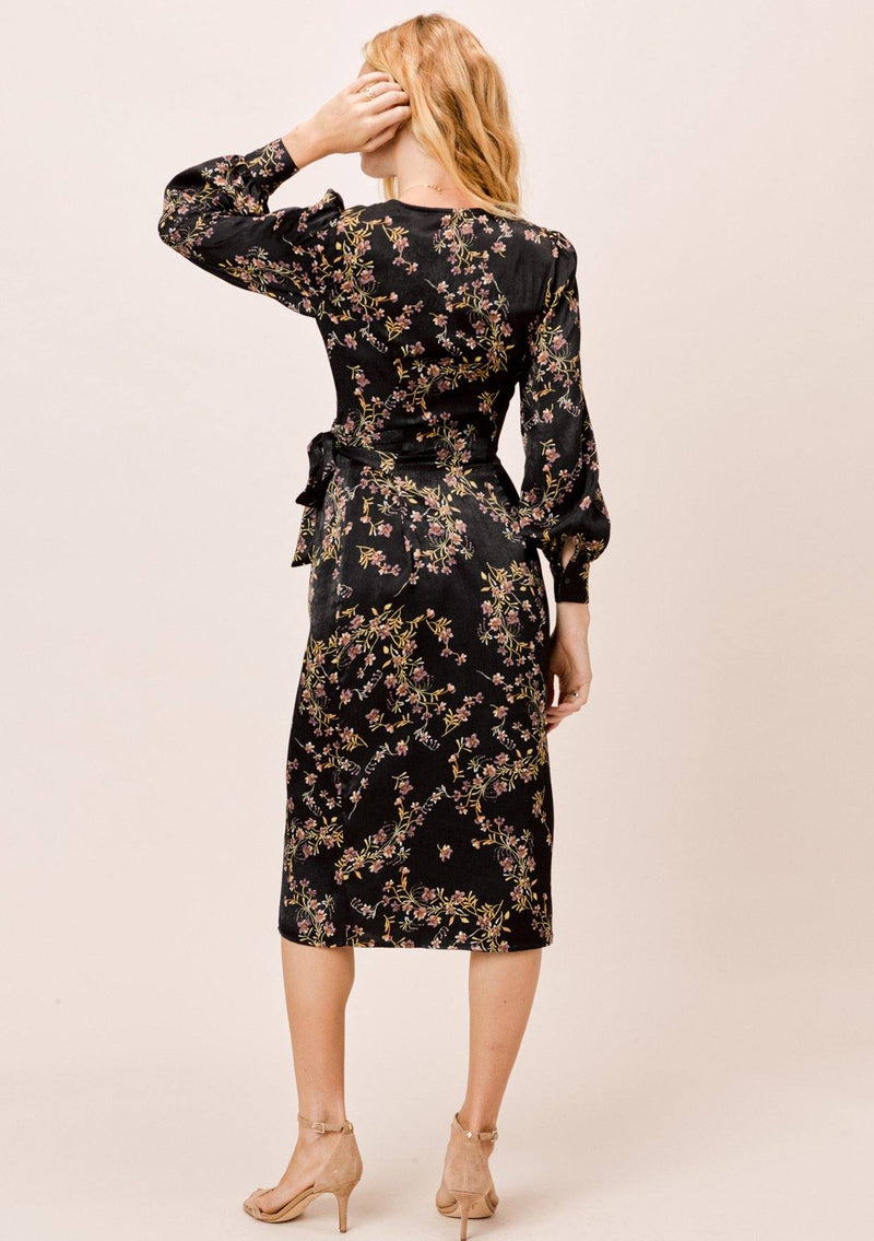 [Color: Black] A gorgeous soft and silky midi wrap dress in a pretty botanical floral print. This classic silhouette features long voluminous sleeves and a belted waist for definition.